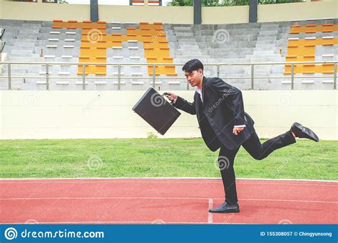 Picture Of Young Businessman Holding A Briefcase And Sprinting On The