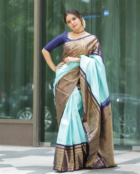 In A Cyan Color Pattu Kanchipuram Saree With Big Border Elbow Length Sleeve Blouse Design And