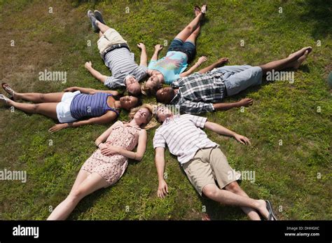 Friends Lying On Grass Asleep In Circle Stock Photo Alamy