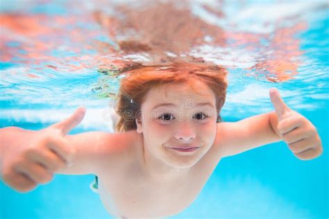 Child Face Underwater With Thumbs Up Kid Swimming In Pool Underwater