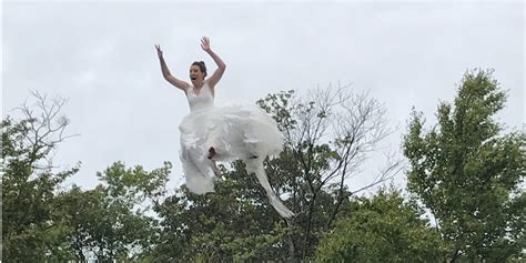 Bride Jumps Off Of A Trampoline And Into A Lake In Her Wedding Dress