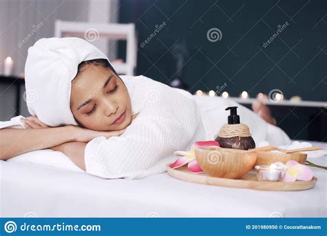 Smiling Asian Woman In White Bathrobe And Headscarf And Lie Down And Relaxing On Bed Preparing