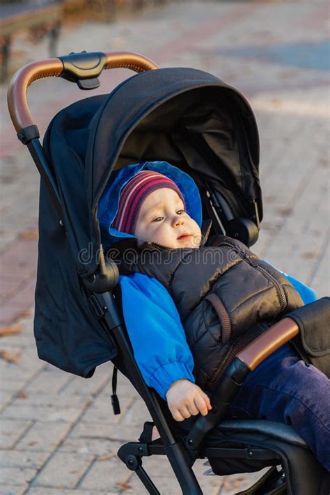 The Little Baby Is Sitting In The Pram Stock Photo Image Of Leisure