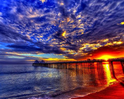 Sunset Beach Sea Pier Platform On Wooden Pillars Sky Clouds Evening