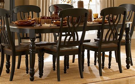 Made of wood, veneer and engineered wood with a rich dark brown finish and diamond matched veneer inlay tabletop Ohana Black Rectangular Extendable Dining Table from ...
