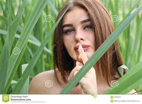 Beautiful Red Haired Girl Is Standing In Tall Grass Stock Image