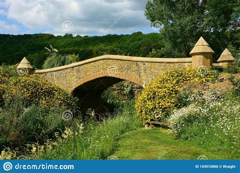 Stone Built Arched Bridge Over Stream Stock Photo Image Of Blooming