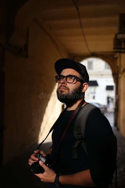 Street Portrait Of A Male Photographer With A Beard In Glasses And A