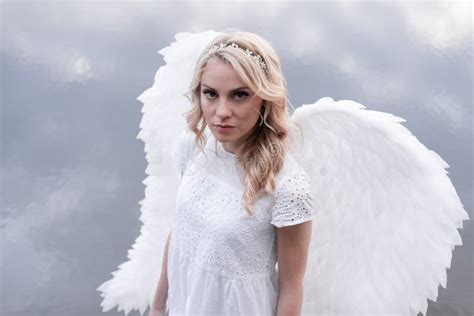 Portrait Of Blonde Woman In White Dress And White Angels Wings Good