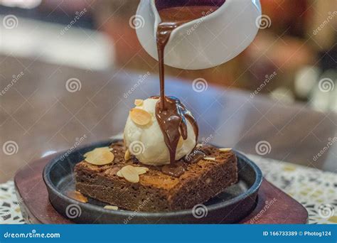 Hot Chocolate Brownie On Sizzling Hot Plate With Vanilla Ice Cream And Topped With Almond Flakes