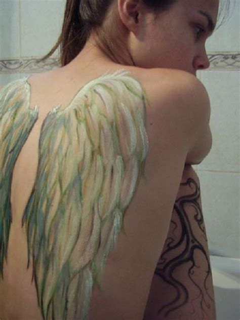 Angel tattoo ideas like this full color sleeve standout with their bright and vivid colors that include a beautiful use of shading, gradients and details. 15 Angel Wing Tattoo Designs to Try - Pretty Designs
