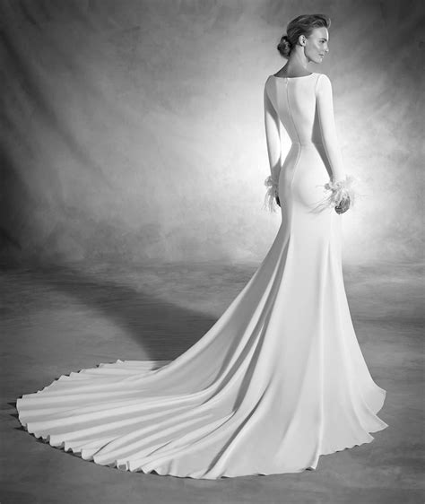 atelier pronovias nuria dress mermaid wedding dress with long sleeves and feathers on the c