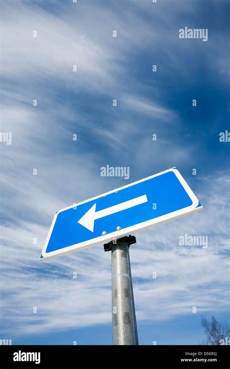 Traffic Sign Arrow Pointing Left Against Sky Hi Res Stock Photography