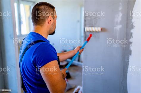 Man Painting Wall With Paint Roller Stock Photo Download Image Now