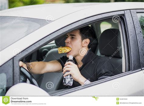 Young Man Driving His Car While Eating Food Stock Photo Image 54451944
