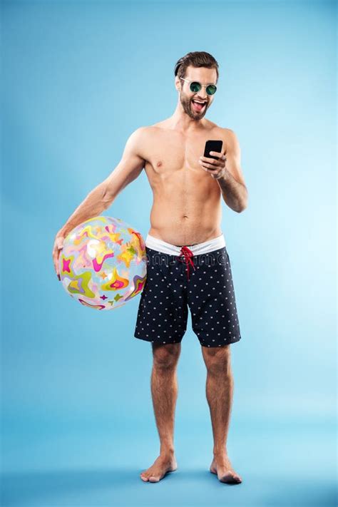 Full Length Portrait Of A Handsome Guy Holding Beach Ball Stock Image