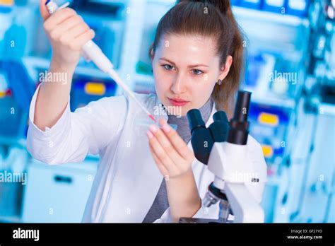 Young Female Researcher Using Pipette In Medical Laboratory Stock Photo