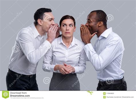 Frightened Woman And Two Men Whispering In Her Ears Stock Photo Image
