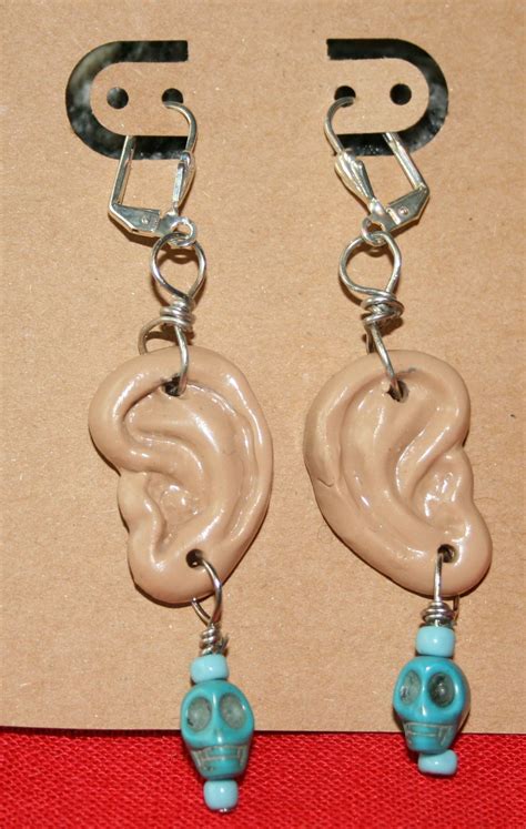 Ear Shaped Earrings Wearing Turquoise Colored Skull Beadscome See