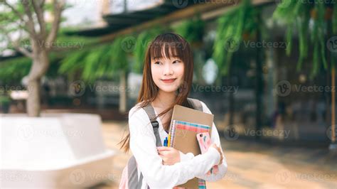 Portrait Of Young Adult Asian College Student Woman With Notebook On