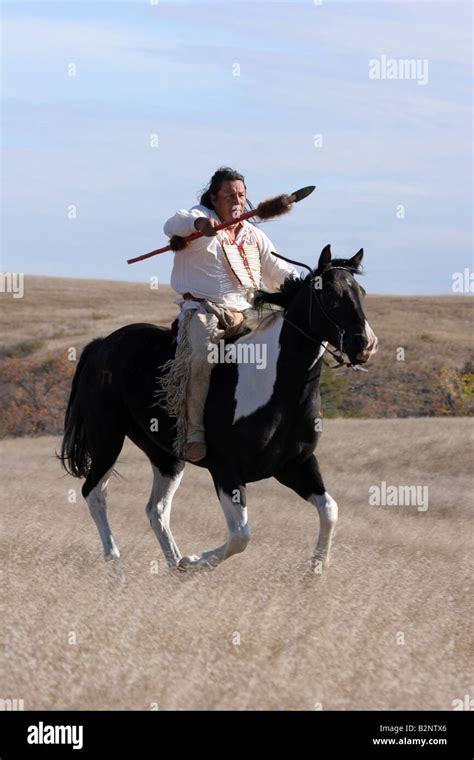 A Native American Sioux Indian On Horseback Running With A Spear In