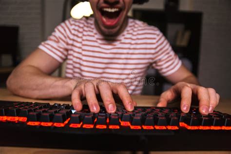 Cropped Image Of Cheerful Gamer Playing Video Games On Computer Stock