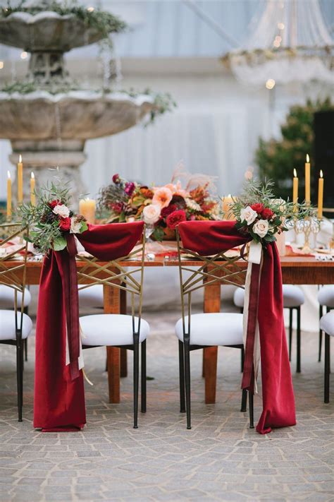 These chairs will be using for bride & groom sitting purpose. Bride and groom chair decor with scarlet fabric draping ...