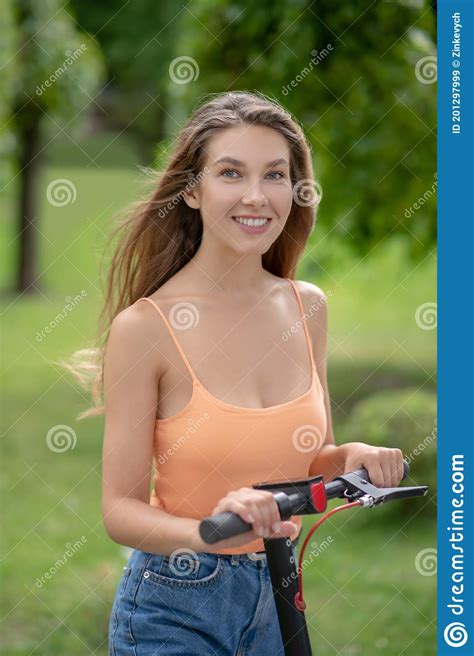 Pretty Smiling Young Girl Riding A Scooter In The Park Stock Image Image Of Vertical Young