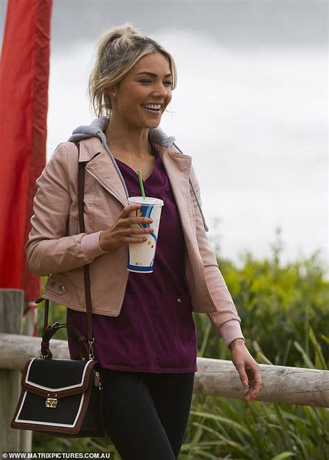 a smiling sam frost is spotted filming scenes for home and away alongside new co star luke