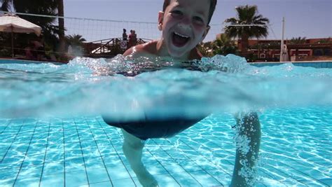 guys in swimming trunks having fun and splashing at the pool outdoors slow motion stock footage