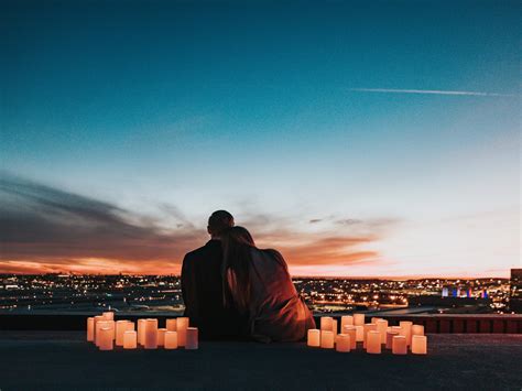 Couple Sitting On The Field Facing The City Wallpaper For You Hd