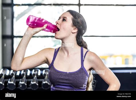 Thirsty Woman Drinking Water On Exercise Ball Stock Photo Alamy