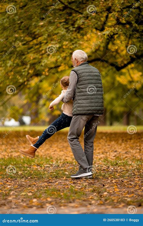 Grandfather Spending Time With His Granddaughter In Park On Autumn Day Stock Image Image Of