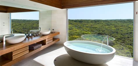 Hotel rooms often include a lounge or seating area in the room to provide a place for guests to sit or relax that isn't on the bed. Best Baths With a View | Travel | Style Magazines