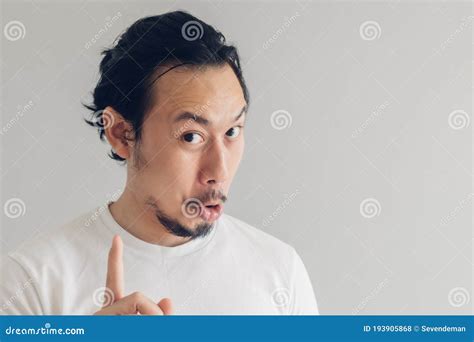 Funny Grinning Smile Face Of Man In White T Shirt And Grey Background