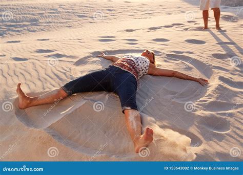 Man Lying On The Beach With Flippers And Rubber Ring Royalty Free Stock