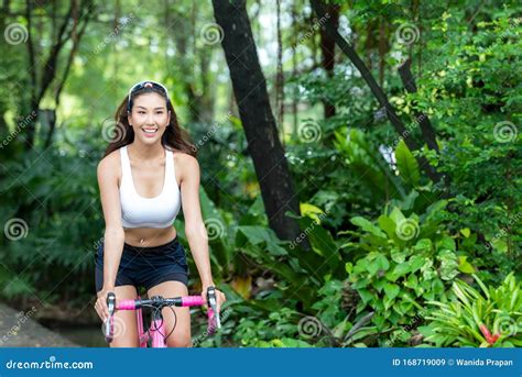Healthy Lifestyle Sporty Asian Woman Riding Bicycles In City Park People Relax And Chill In The
