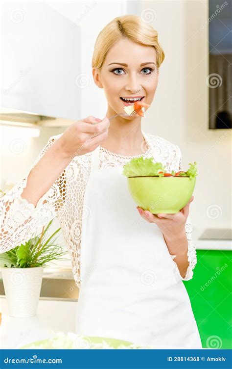 Portrait Of A Beautiful Young Woman Eating Vegetable Salad Stock Photo