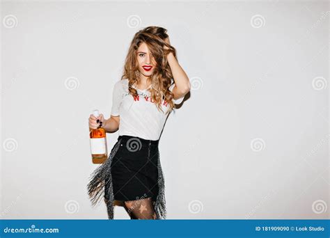 Good Looking Girl Plays With Her Hair While Posing After Event Indoor