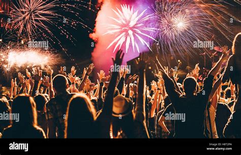 cheering crowd and fireworks - New Year celebration concept Stock Photo - Alamy
