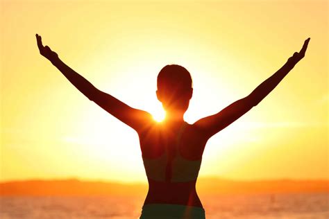 Freedom Woman With Open Arms Silhouette In Sunrise Against Sun Flare