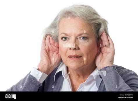 Mature Woman Holding Hands To Ear Stock Photo Alamy