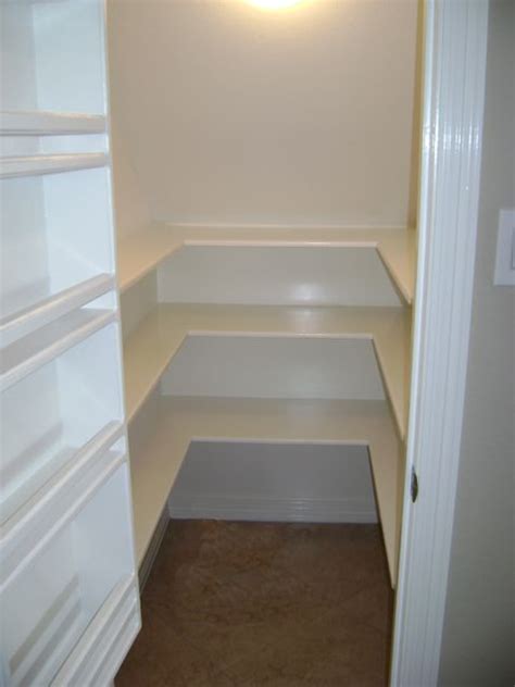 Storage pantries slide out from under the stairs to show off shelves that can house most any sized food items. Pantry under the stairs, getting shelving ideas....nice ...