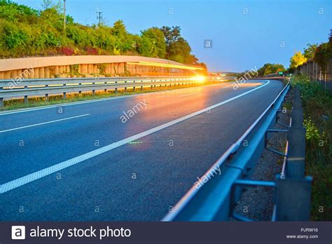 Highway At Twilight With Light Trails High Traffic Road With