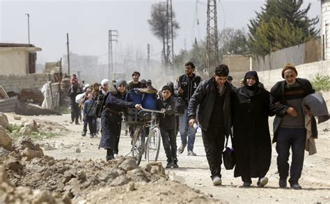 ‘we were dying in there thousands of syrians flee rebel enclave the new york times