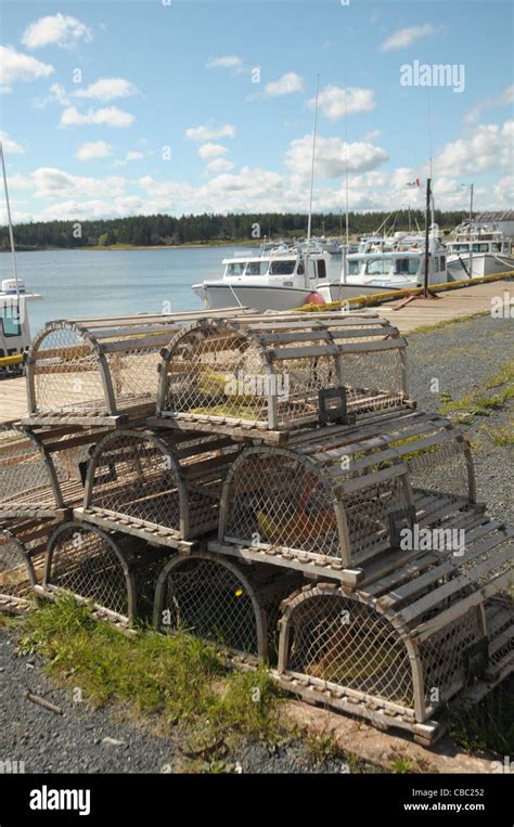 Lobster Traps Grace The Foreground As Fishing Boats Are Tied To The