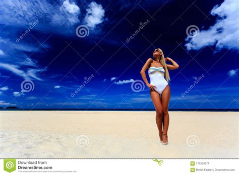 Model In White Swimsuit Posing At The Beach Stock Image Image Of Season Clouds 117534377