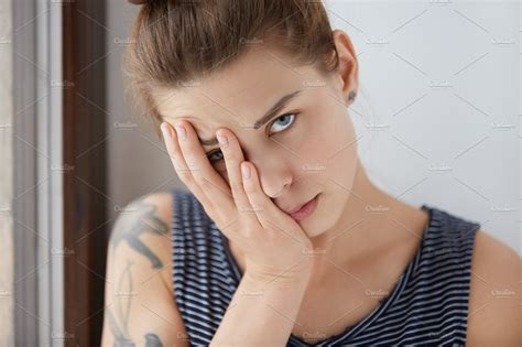 Beautiful Portrait Of Bored Female Resting Half Of Her Face On Her Palm