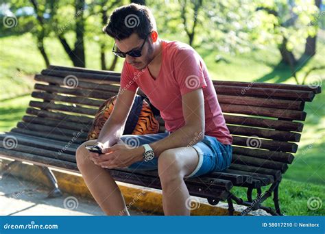 Handsome Young Man Using His Mobile Phone In The Street Stock Photo