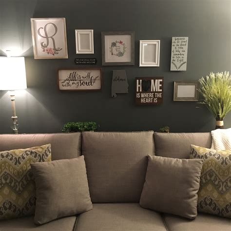 A small carpeted living room with a large coffee table in front of the enclosed fireplace. Gallery wall in living room. Sofa table behind couch ...